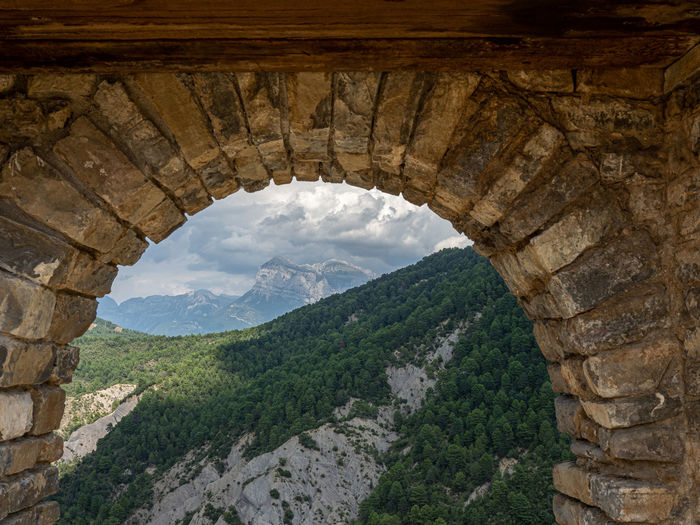 Scenic view of mountains seen through arch