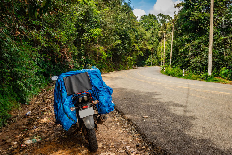 Solo traveler loaded bike with isolated road and amazing background