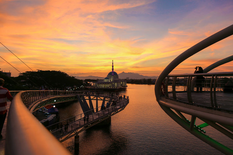 The new landmark of kuching city, the golden bridge over river during sunset