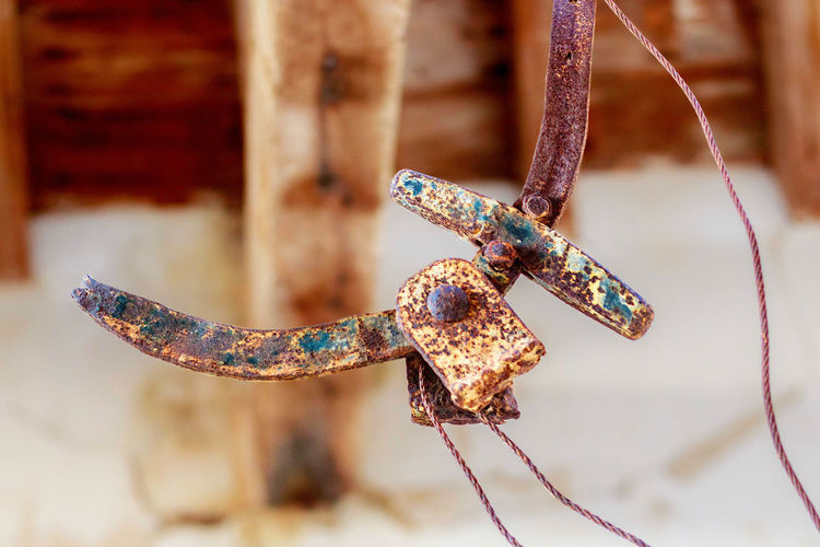Close-up of weathered and rusty hook of a scale in an abandoned mine building, mazarron, spain