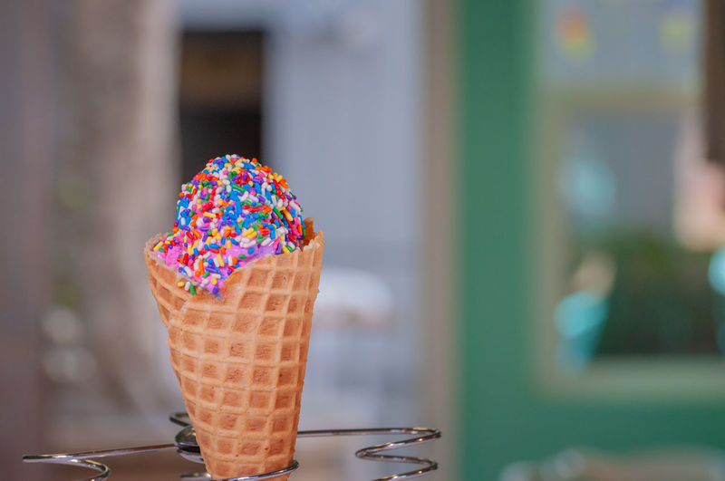 Close-up of ice cream cone with colorful sprinkles