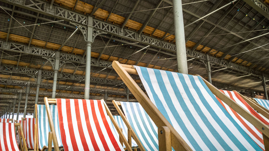 Low angle view of deck chairs against ceiling
