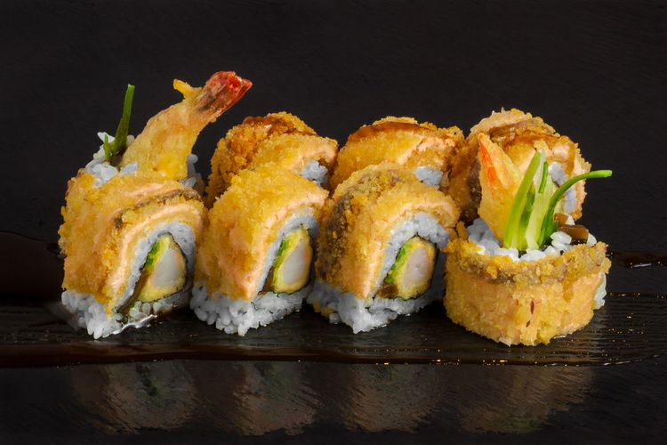 Close-up of sushi on black background
