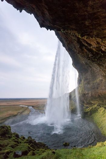 Scenic view of seljalandsfoss waterfall against sky