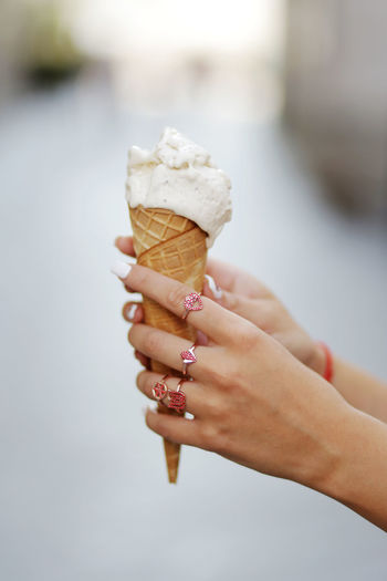 Cropped hands of woman holding ice cream cone
