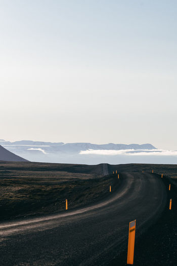 Road passing through landscape against sky