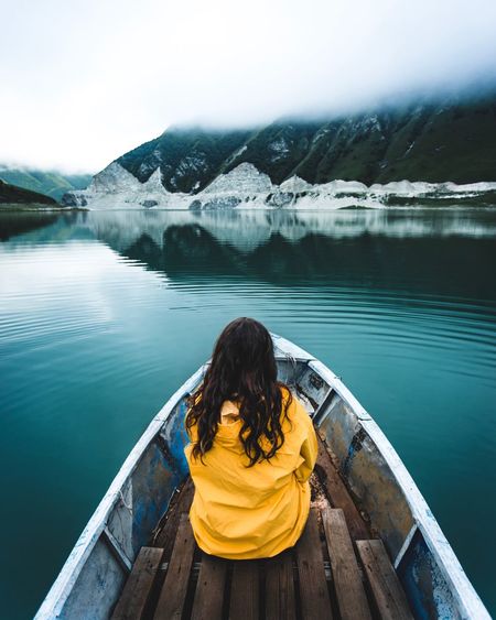 Rear view of woman looking at lake