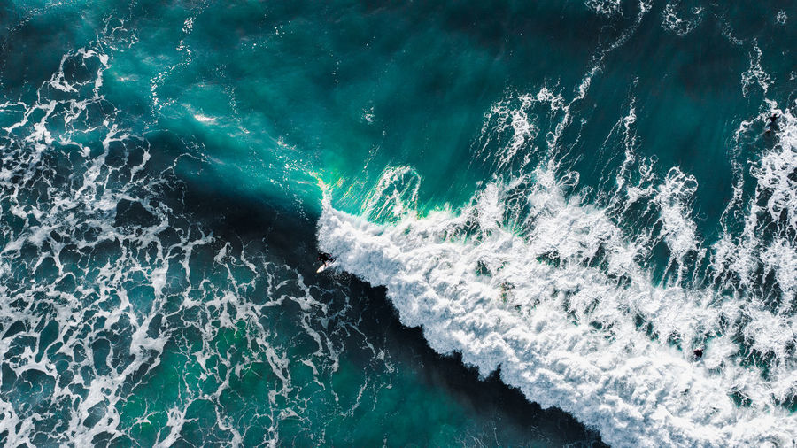 High angle view of surfers and waves.