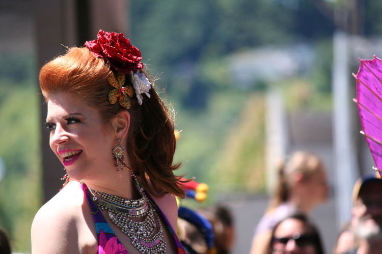 Happy beautiful woman looking away during gay parade