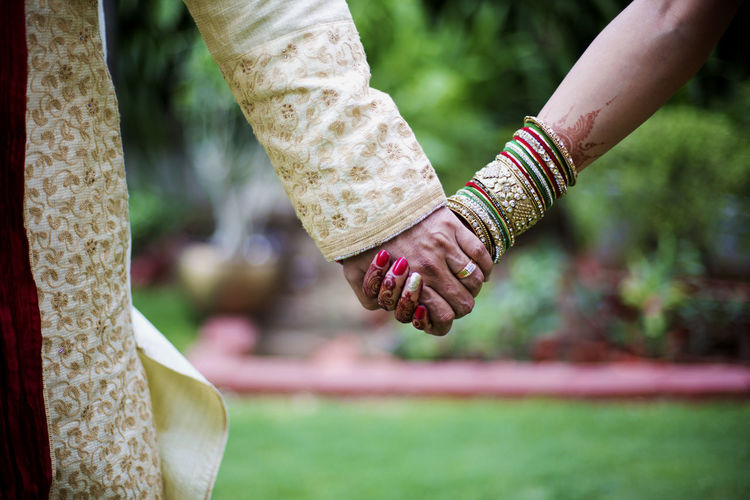 Close-up of couple holding hands