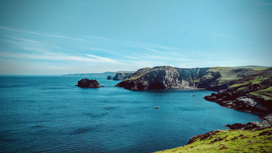 Scenic view of sea against blue sky