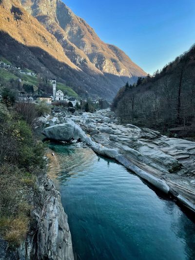 Scenic view of river amidst mountains against sky in lavertezzo