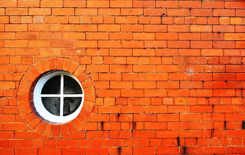 Circle shape window on brick wall 