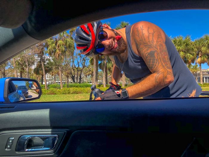Portrait of man looking through car window