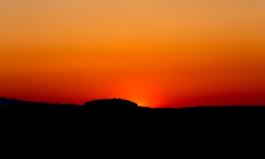 Scenic view of silhouette landscape at sunset