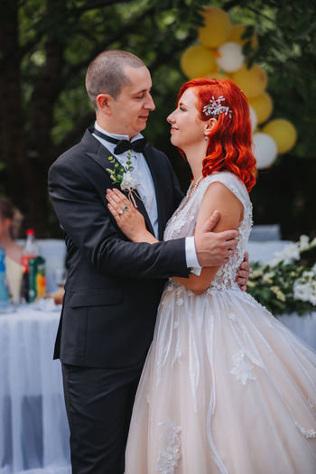 Rear view of couple holding hands