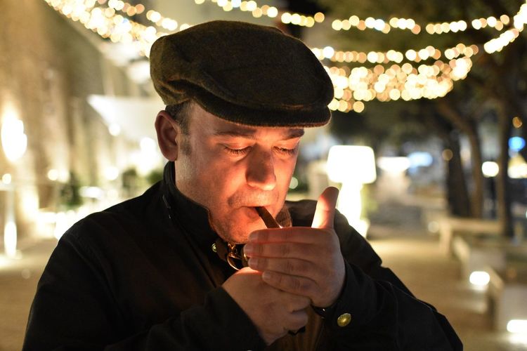 Close-up of man lighting cigarette in winter