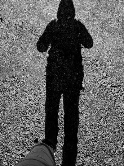 Low section of man standing on street