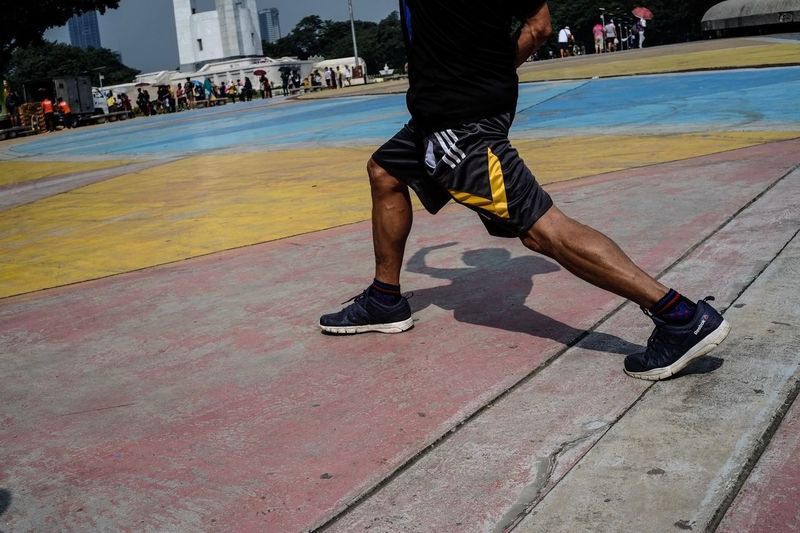 Low section of man standing on basketball court