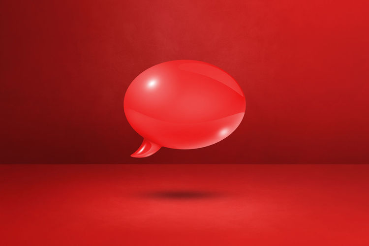 Close-up of balloons against red background
