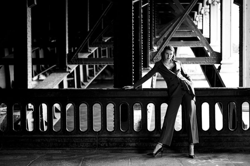 Fashion woman standing under the bridge in paris 