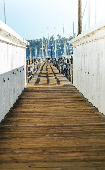 View of wooden pier leading towards sea
