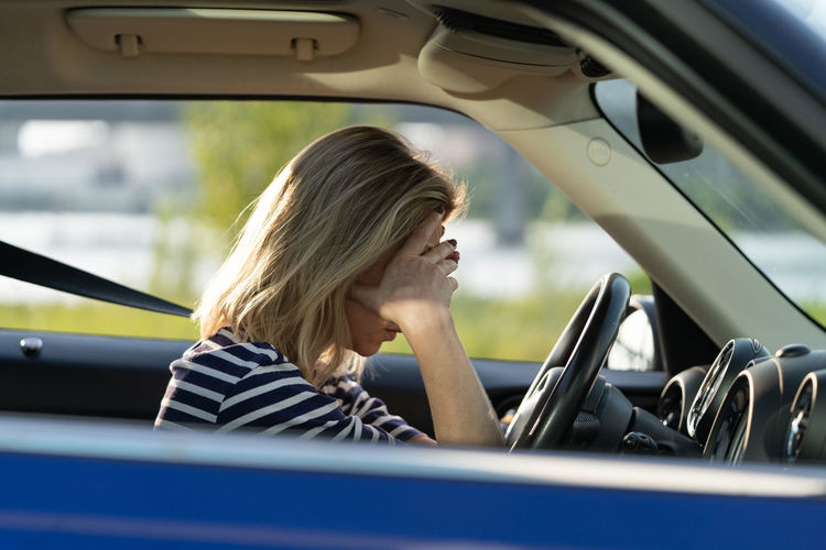 Girl driver feeling doubtful confused about difficult decision, suffering from burnout, life crisis