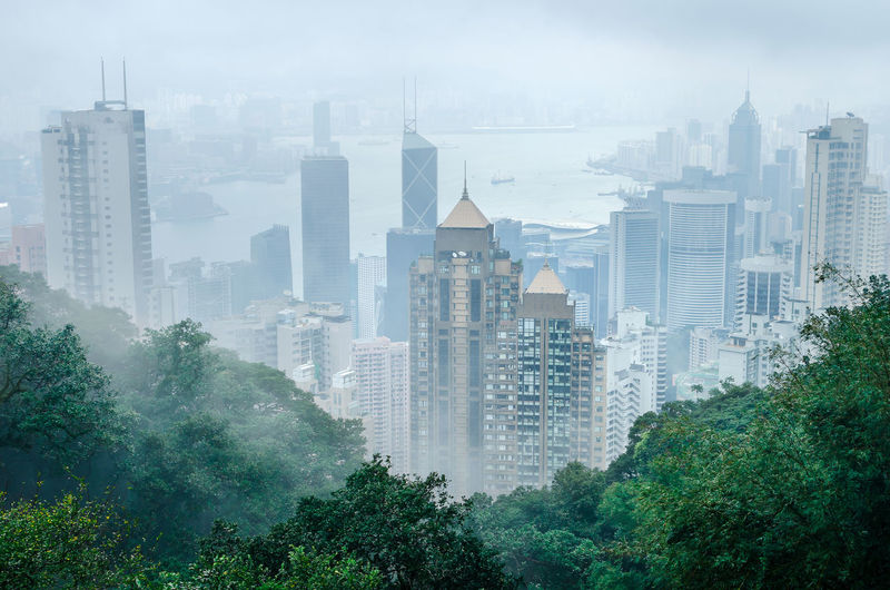 Hong kong city in fog weather viewed from victoria peak, a hill on the western half of hong kong