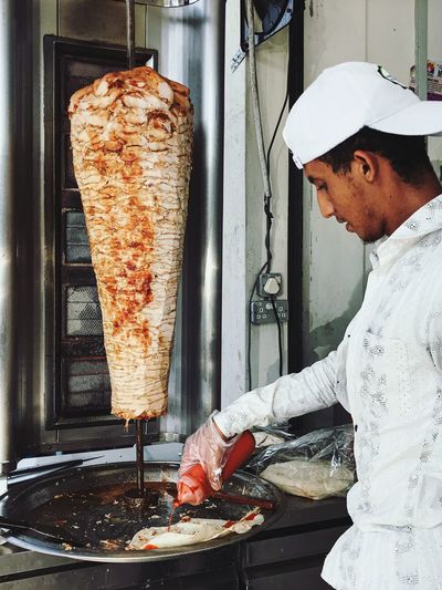 Man preparing shawarma in restaurant