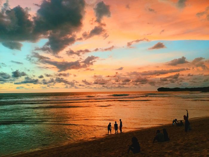 People on beach at sunset