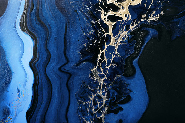 Dark blue waves in abstract ocean and golden inclusion. liquid acrylic artwork. marble effect 