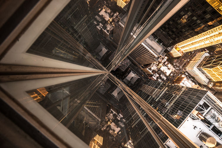 High angle view of buildings in city seen through glass elevator
