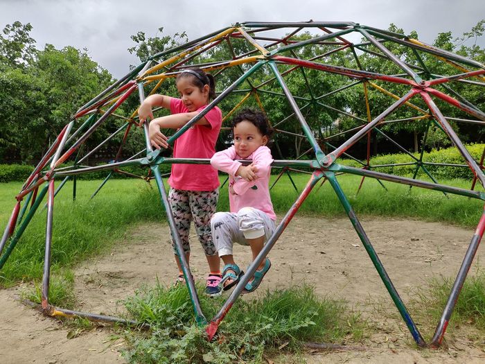 Girls playing at jungle gym in playground