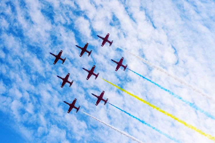Low angle view of airshow against sky