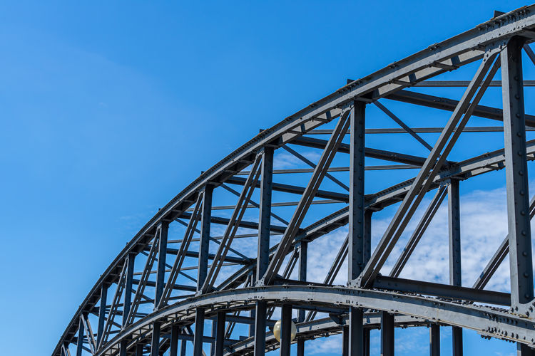 Low angle view of bridge against clear blue sky