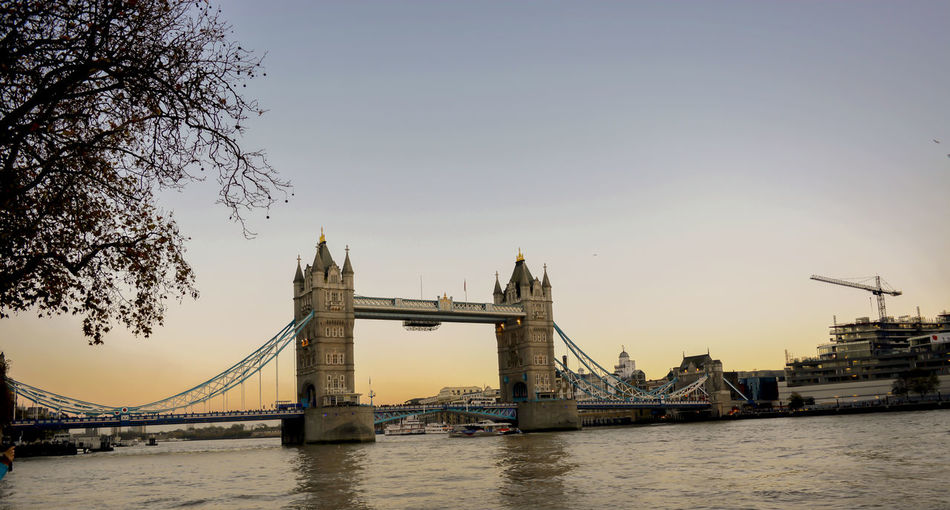 Low angle view of tower bridge over thames river at sunset