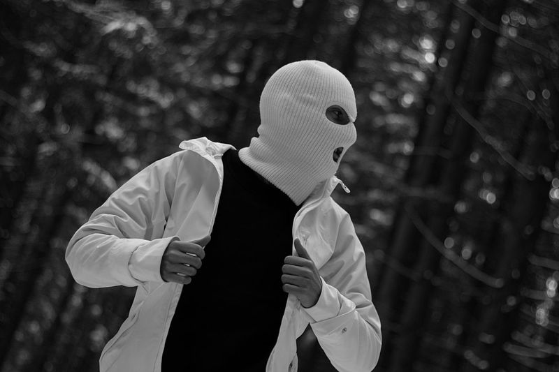 Man wearing mask against trees