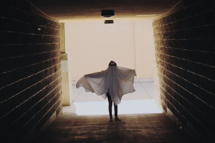 Low angle view of ghost walking in tunnel