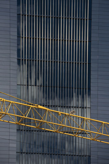 Metal railing of modern building and crane