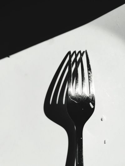 High angle view of fork on table against black background