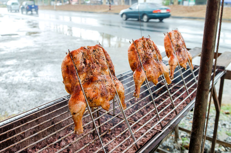 Close-up of chicken meat roasting on barbecue grill