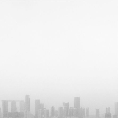High section of cityscape against sky during foggy weather