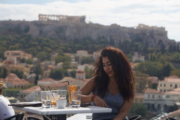 Young woman in athens enjoying view of the acropolis 