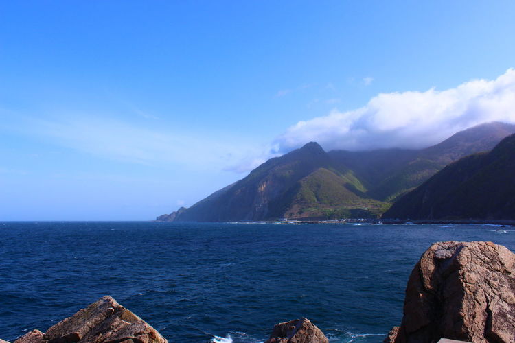 Scenic view of sea against blue sky