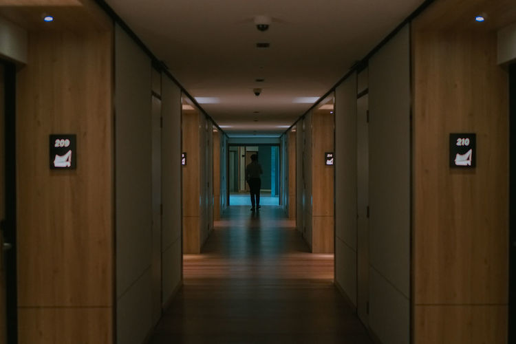Hotel's corridor with someone walking in the middle