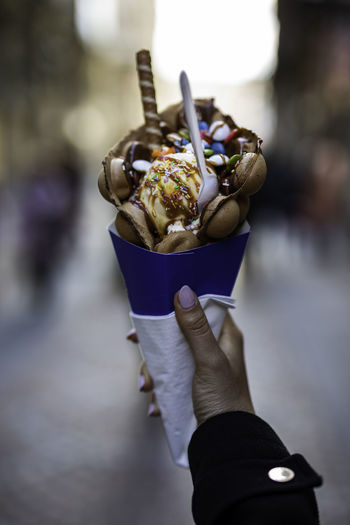 Close-up of hand holding ice cream outdoors