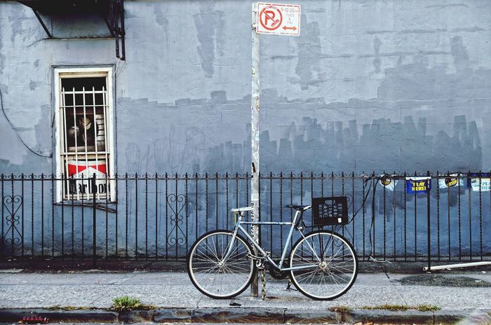 Side view of a bicycle parked against railing