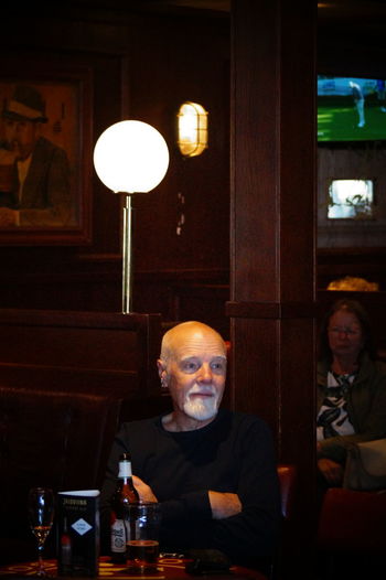 Portrait of happy man sitting in restaurant