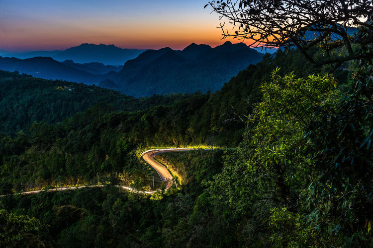 High angle view of road amidst green mountains