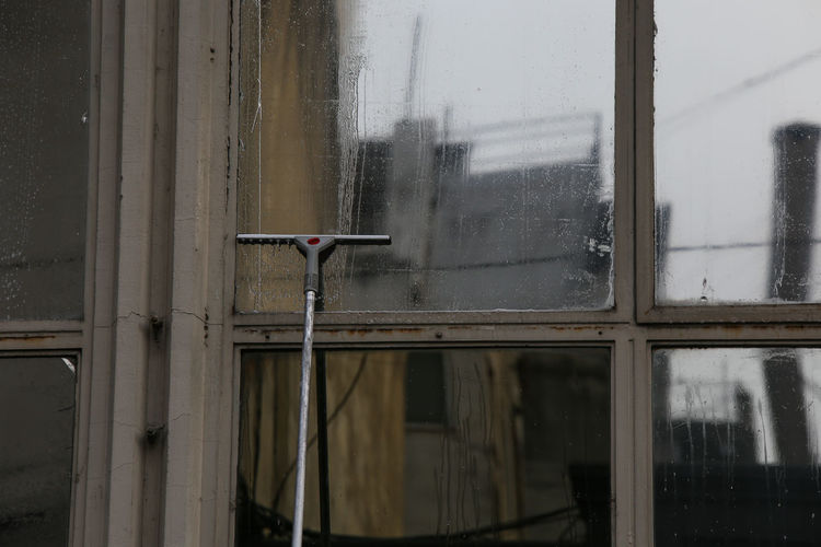 Raindrops on glass window of building